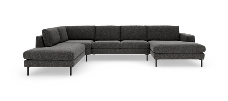 Mørkegrå modulopbygget hjørnesofa i L‑form med chaiselong, på slanke sorte ben, frilagt på hvid baggrund.