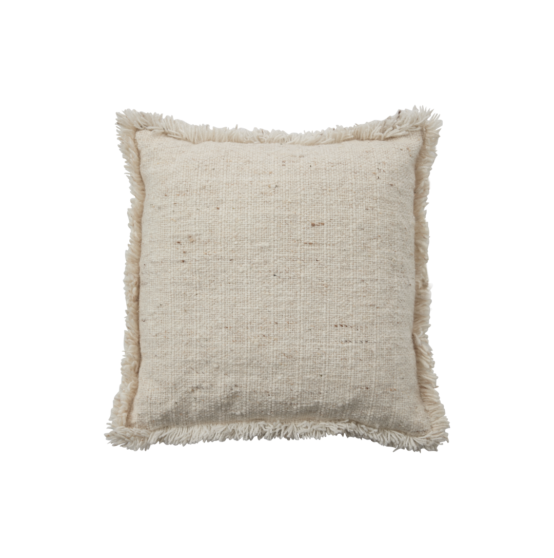 Dråber af beige væske på sort baggrund i et minimalistisk, asymmetrisk udsnit.