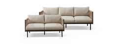 To beige modulsofaer med slanke mørke ben og vævede sidepaneler, frontvisning mod hvid baggrund.