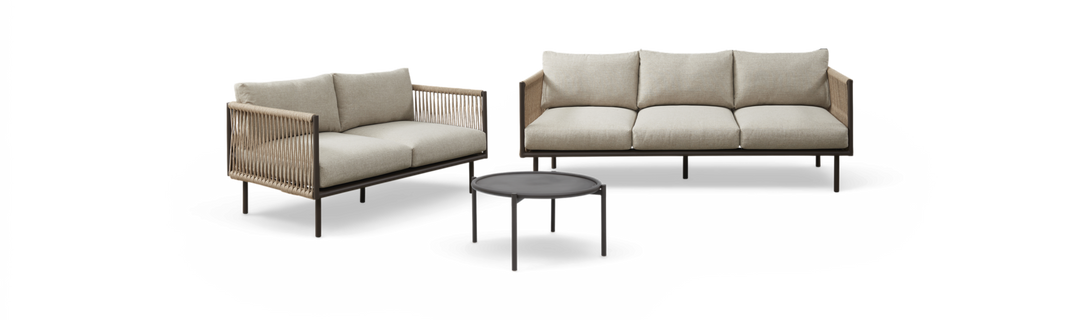 Udendørs loungesæt med to beige sofaer med rebdetaljer og et rundt sort sofabord, fritlagt på hvid baggrund.