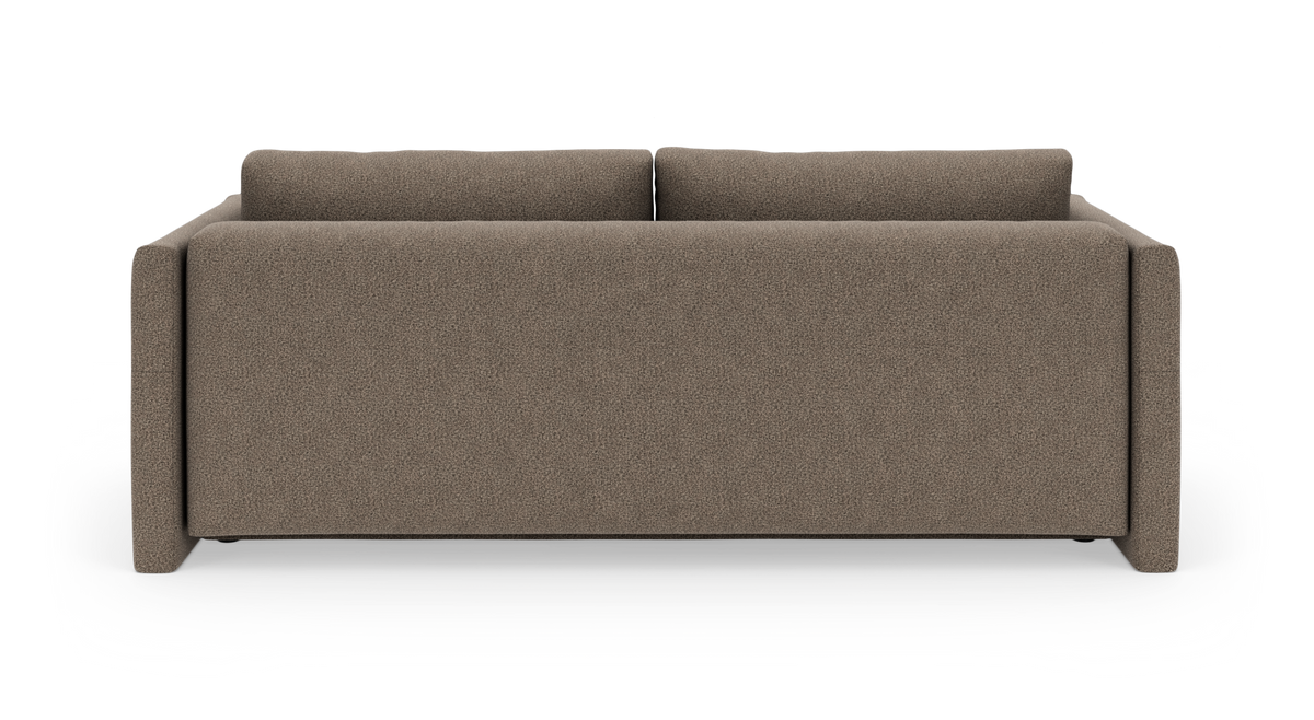 Brun stofsofa set bagfra på hvid baggrund.