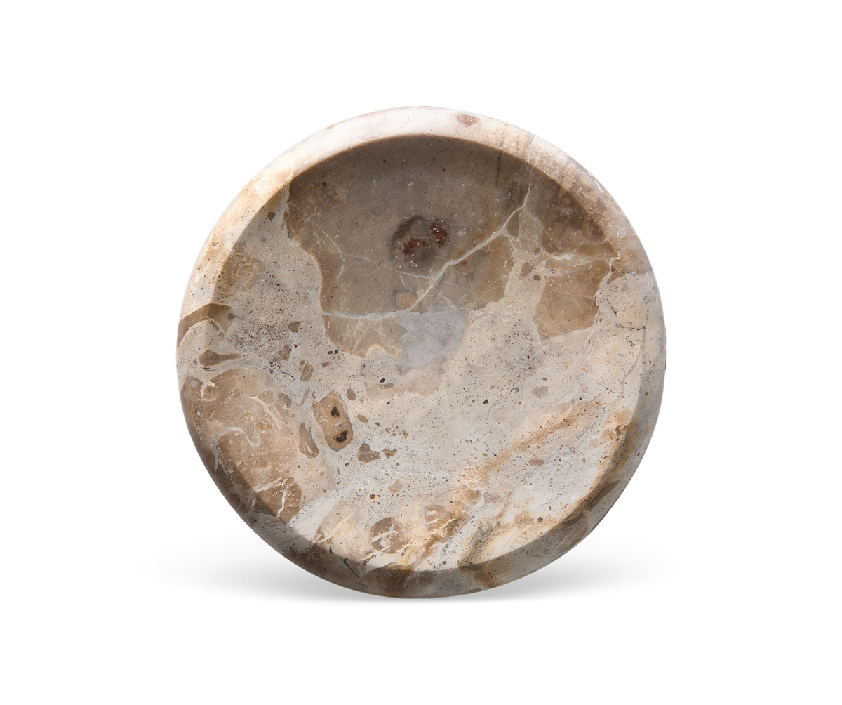Rund skål i beige marmor med naturlig åretegning, set oppefra.
