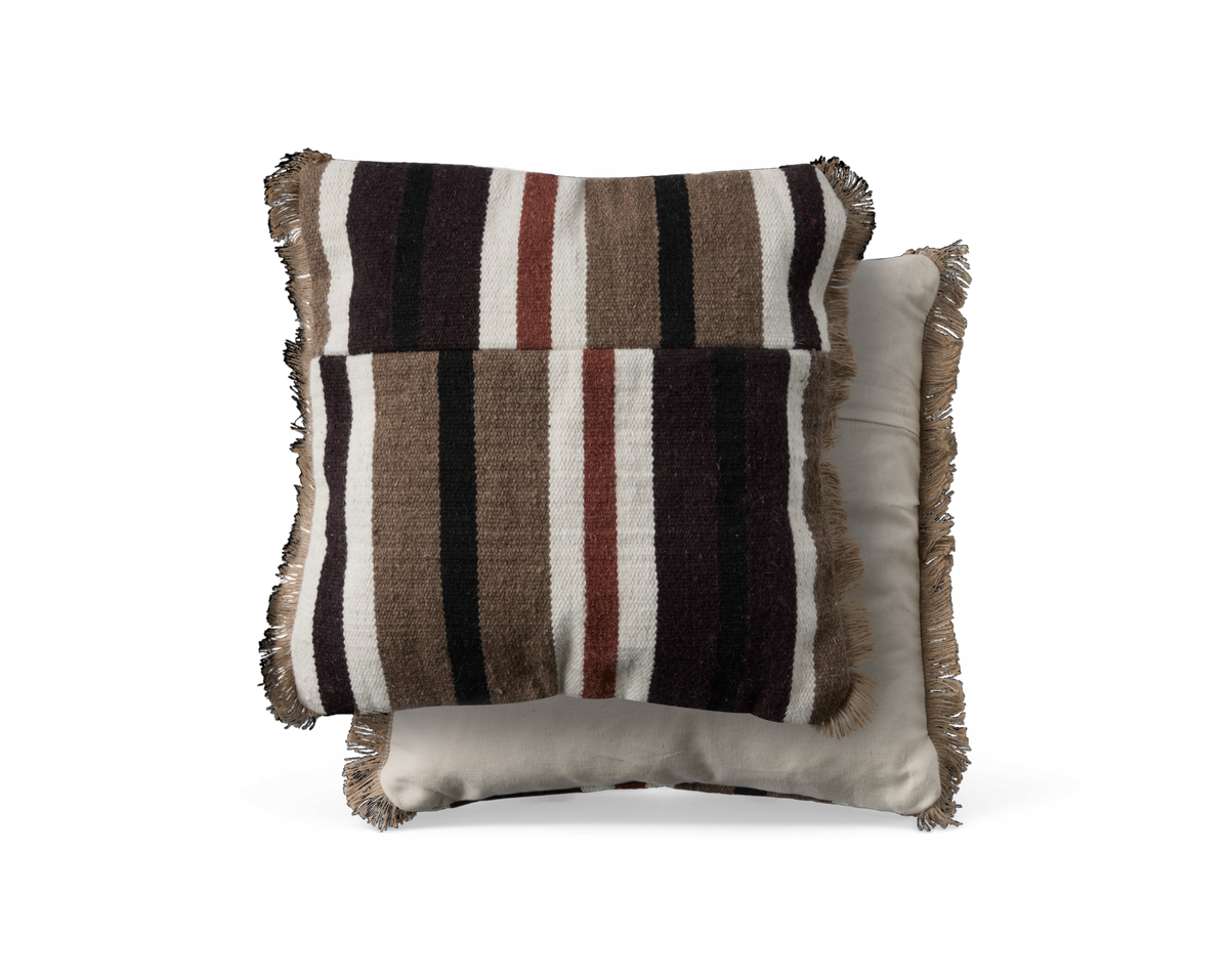 To puder med frynser, øverste med brede striber i brun, sort, hvid og rust, nederste ensfarvet beige, frilagt mod sort baggrund.