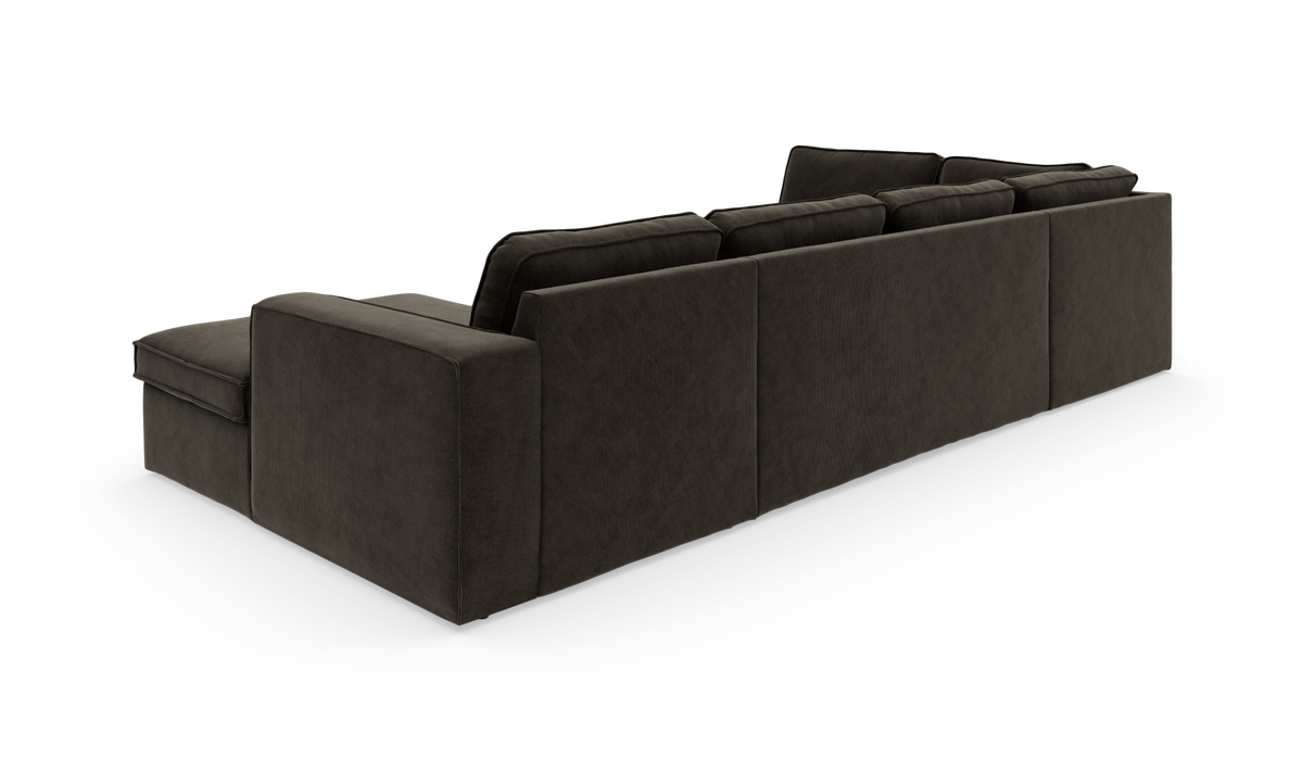 Mørkegrå modulsofa med chaiselong, set skråt bagfra på hvid baggrund.