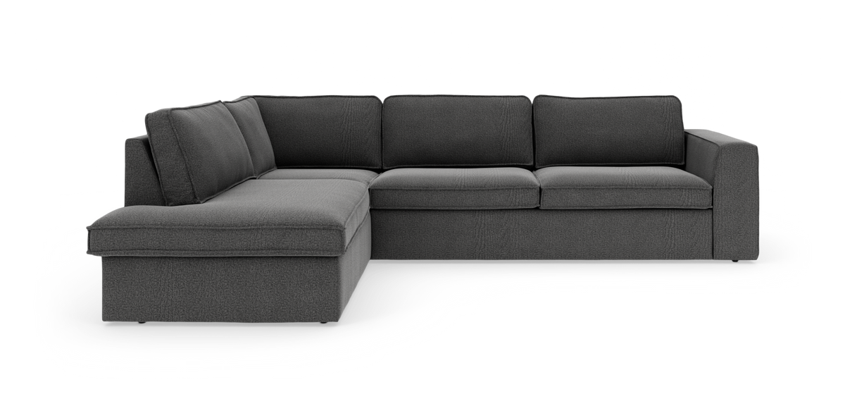 Mørkegrå hjørnesofa med chaiselong til venstre i moderne, rummelig stil.