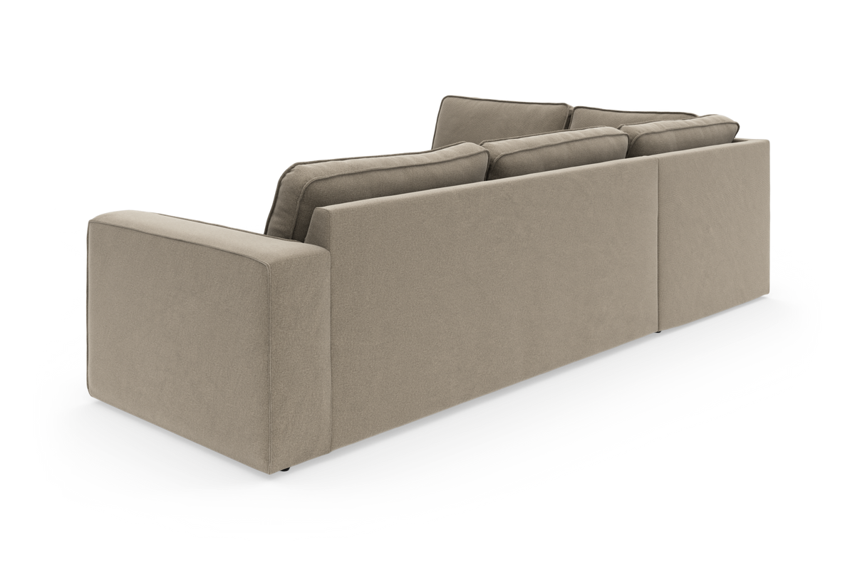 Beige modulsofa set bagfra i studiemiljø, vinklet visning.
