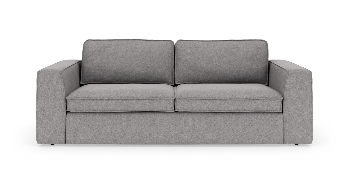 Grå tresæders sofa med brede armlæn, frilagt på hvid baggrund.