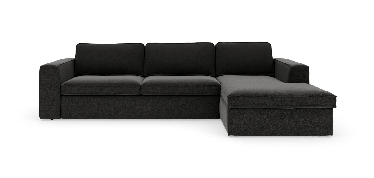 Mørkegrå hjørnesofa med chaiselong til højre, tre ryghynder og brede armlæn.