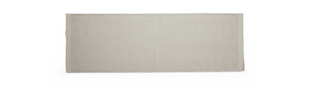 Lys beige rektangulær løber med vævet struktur på hvid baggrund.
