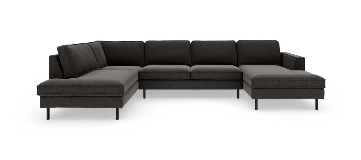 Mørkegrå modulsofa i U‑form med chaiselong i begge ender, frilagt på hvid baggrund.