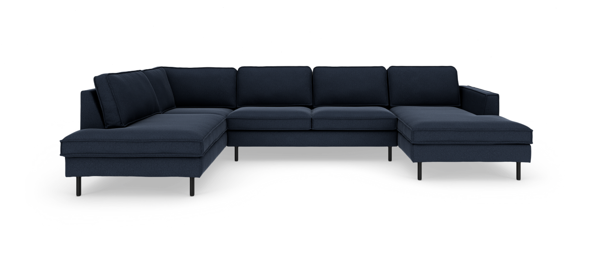 Mørkeblå modulsofa i U‑form med chaiselong i begge ender, fritstående mod hvid baggrund.
