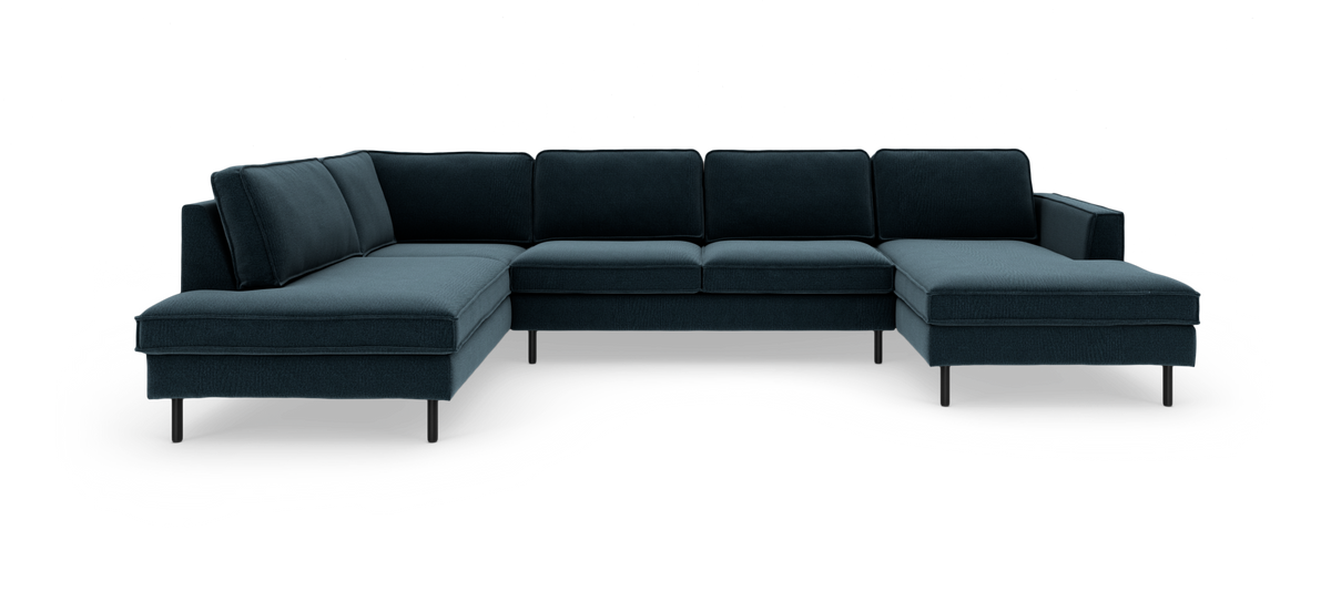 Mørkeblå modulhjørnesofa i U‑form med chaiselong i begge ender og slanke metalben, fritstående på hvid baggrund.