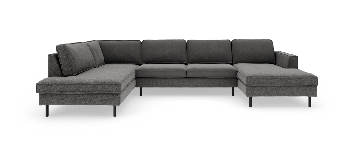 Mørkegrå modulsofa i U‑form med chaiselong i begge ender, fritstående mod hvid baggrund.