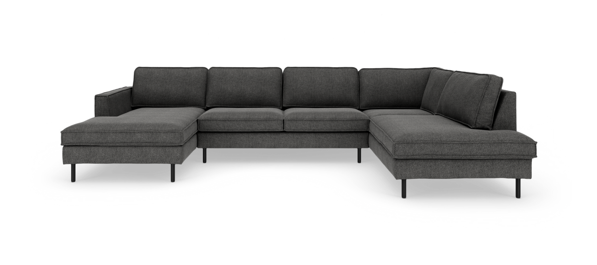 Mørkegrå U‑formet modulsofa med chaiselong i begge ender og slanke sorte ben.