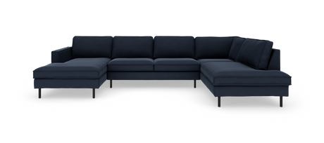 Mørkeblå modulsofa i L-form med chaiselong i begge ender mod hvid baggrund.
