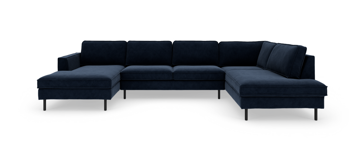 Stor U-formet hjørnesofa i mørk marineblå fløjl med chaiselong i begge ender og sorte metalben.