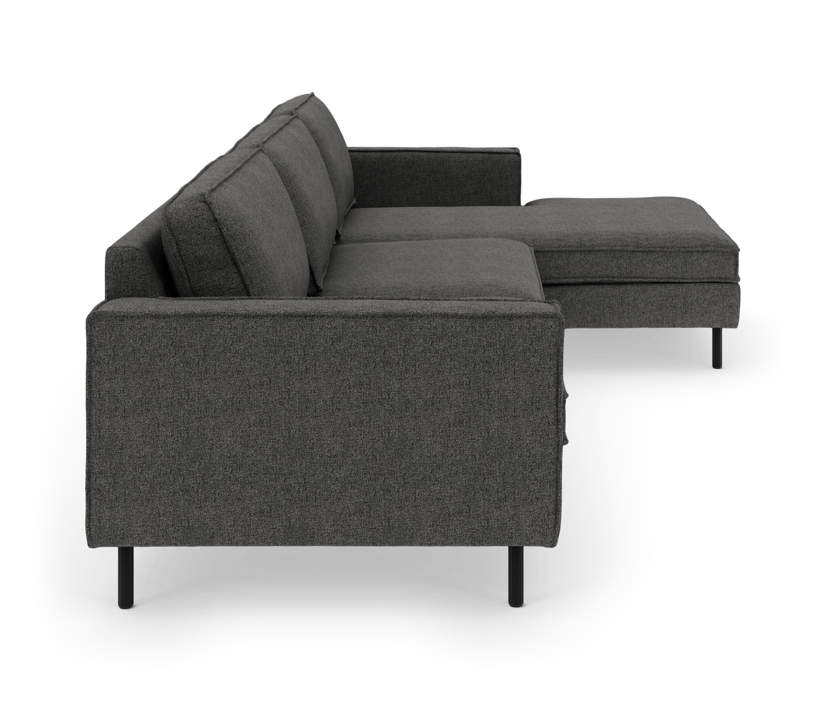 Mørkegrå modulsofa med chaiselong, set fra siden, frilagt på hvid baggrund.