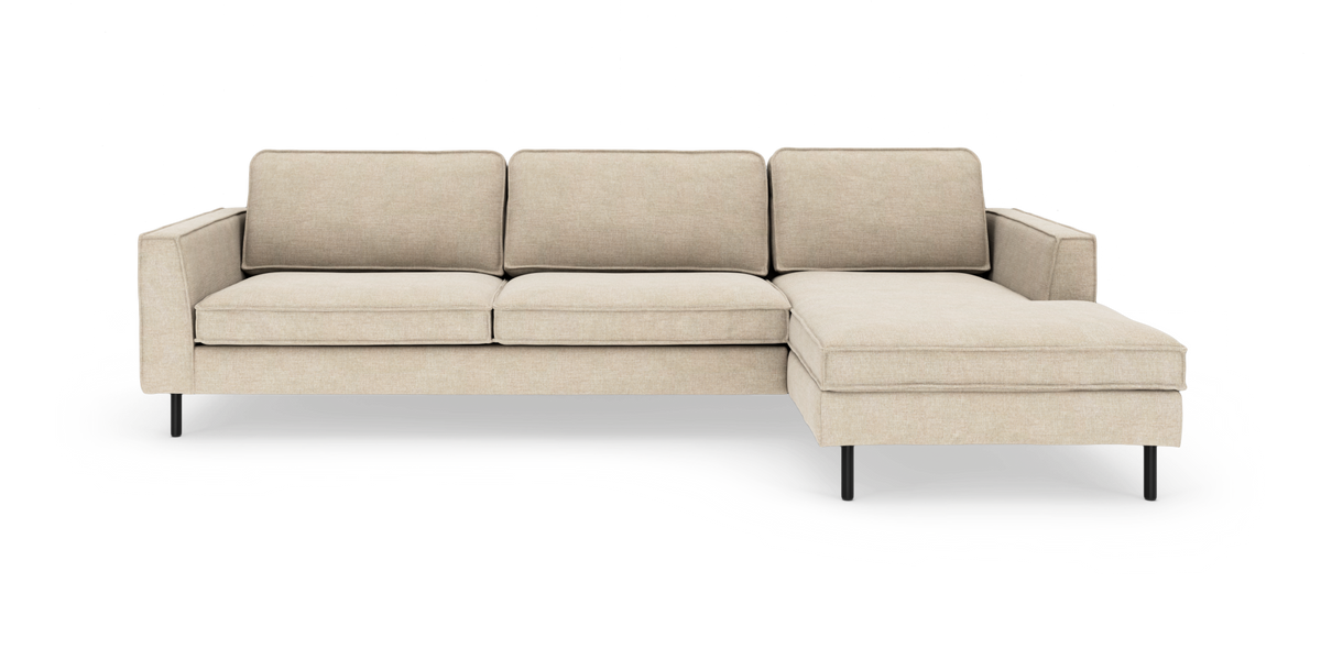 Beige hjørnesofa med chaiselong til højre på slanke sorte ben, frilagt på hvid baggrund.