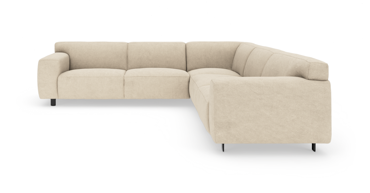 Beigefarvet L‑formet modulsofa med lave metalben, vist i frontvinkel på hvid baggrund.
