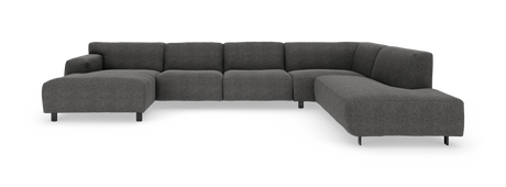 Stor L‑formet modulsofa i mørkegråt stof med afrundede hjørner og slanke sorte ben, frilagt på hvid baggrund.