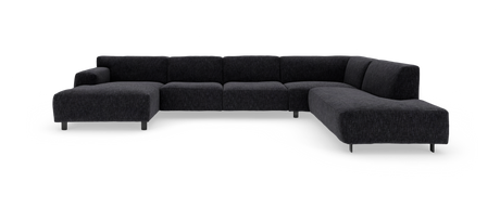 Mørkegrå U-formet modulsofa i stof med lav ryg og slanke ben, frilagt på hvid baggrund.