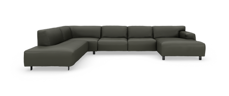 Mørkegrøn modulsofa i U‑form på studiobaggrund.