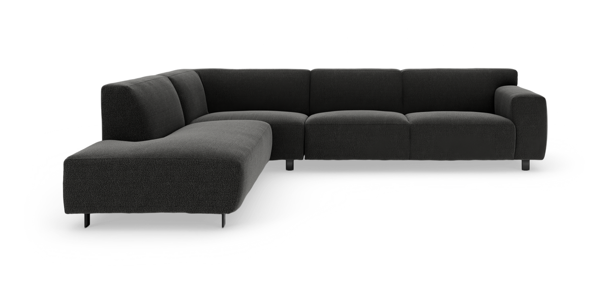 Mørkegrå L‑formet modulsofa med bred chaiselong og afrundede hjørner, studiefoto på hvid baggrund.