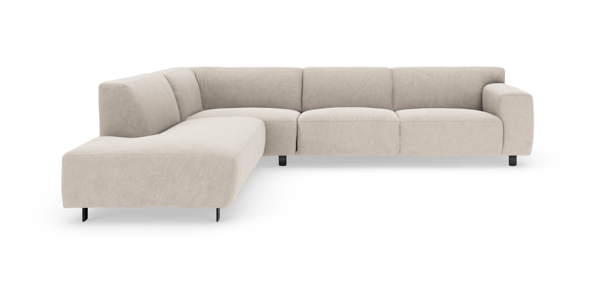 L‑formet modulsofa i beige cord/fløjl med lav profil og sorte ben.