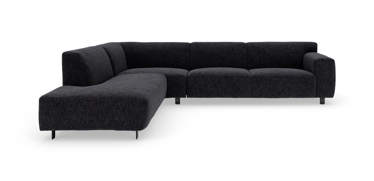 Mørkegrå L‑formet modulsofa med chaiselong, frilagt studieoptagelse.