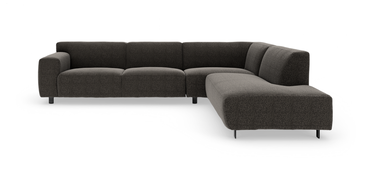 Mørkegrå L‑formet modulsofa i stof på hvid baggrund.