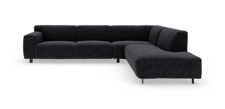 Mørkegrå L‑formet modulsofa med afrundede sæder og metalben, fotograferet i studie fra frontvinkel.