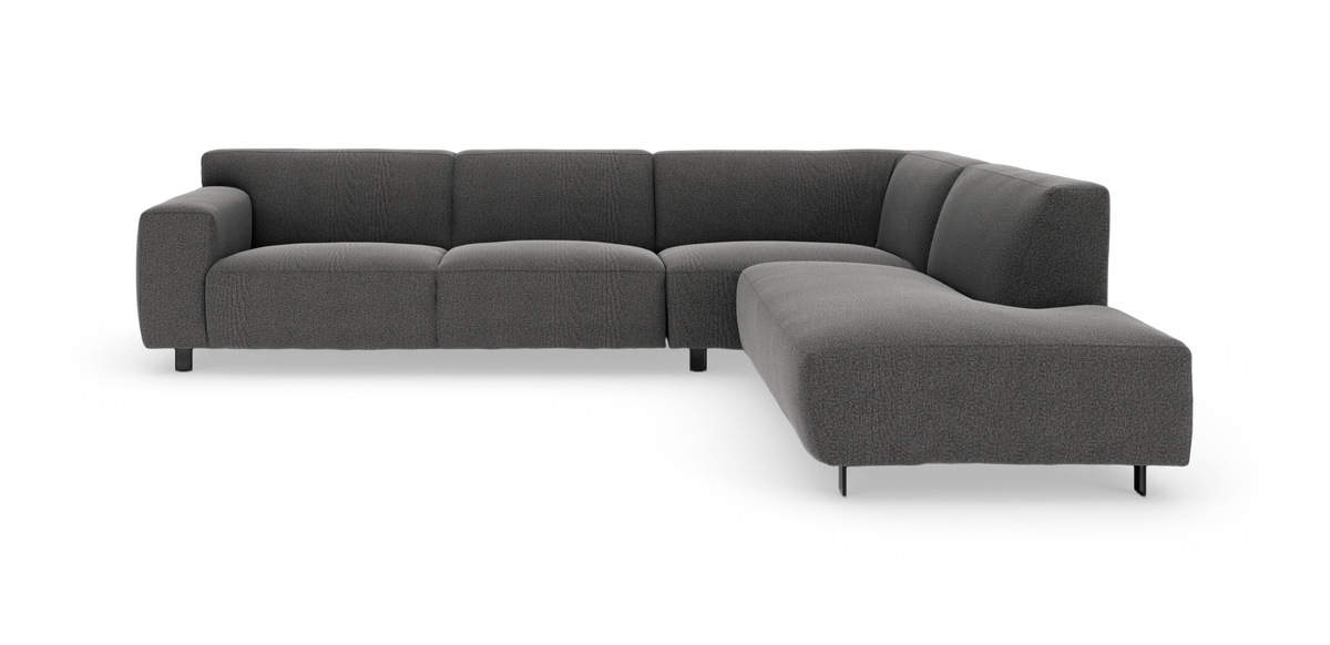 Mørkegrå L‑formet modulsofa med chaiselong til højre, set skråt forfra mod hvid baggrund.