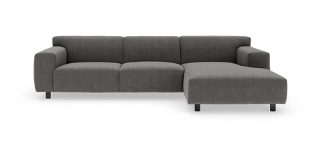 Mørkegrå modulsofa med højre chaiselong i studiemiljø.