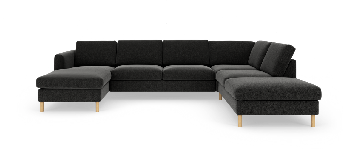 Mørkegrå U‑formet modulsofa med træben, frilagt på hvid baggrund.