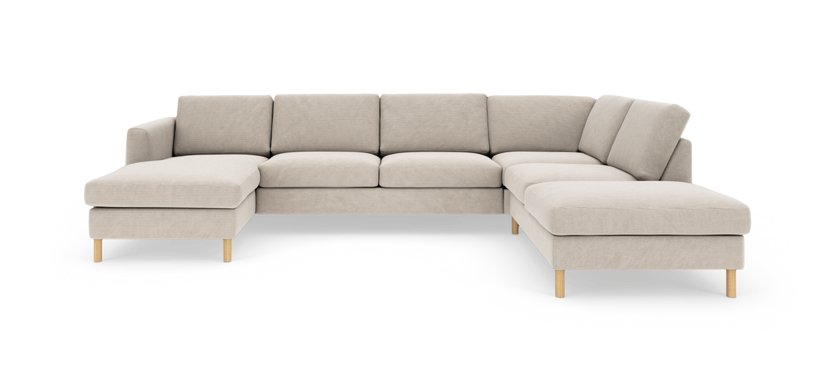 Beige U-formet modulsofa med træben og løse rygpuder, fotograferet i studie.