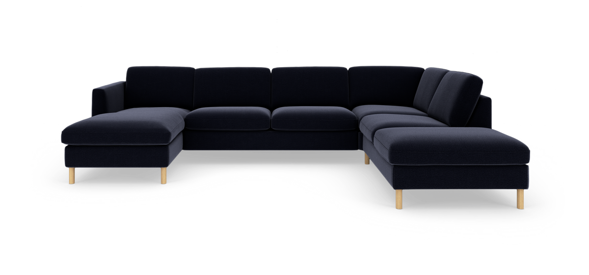 Mørkeblå U-formet modulsofa med træben på hvid studioscene.