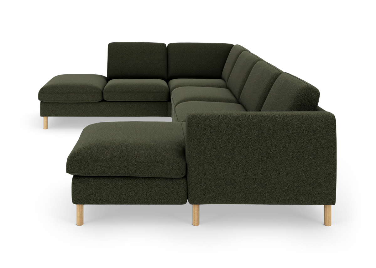 Mørkegrøn modulsofa i U‑form med træben, fritlagt på hvid baggrund.