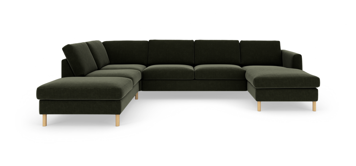 Grøn modulsofa i L‑form med chaiselong og træben, frilagt på hvid baggrund.