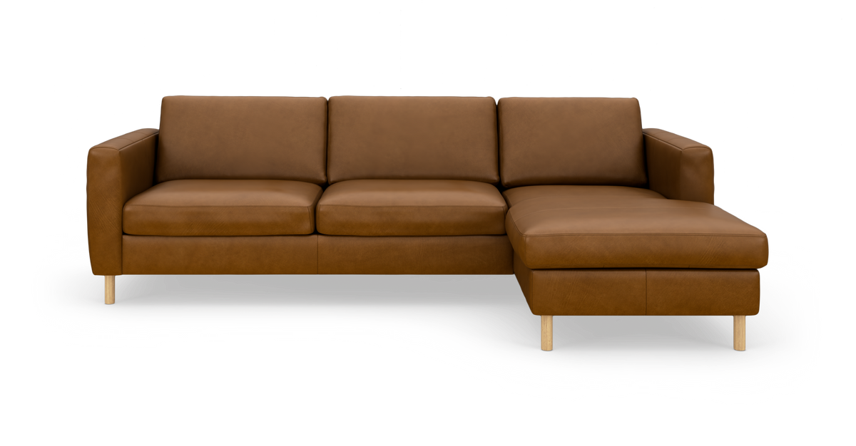 Brun læderhjørnesofa med chaiselong til højre og lyse træben, frilagt mod hvid baggrund.