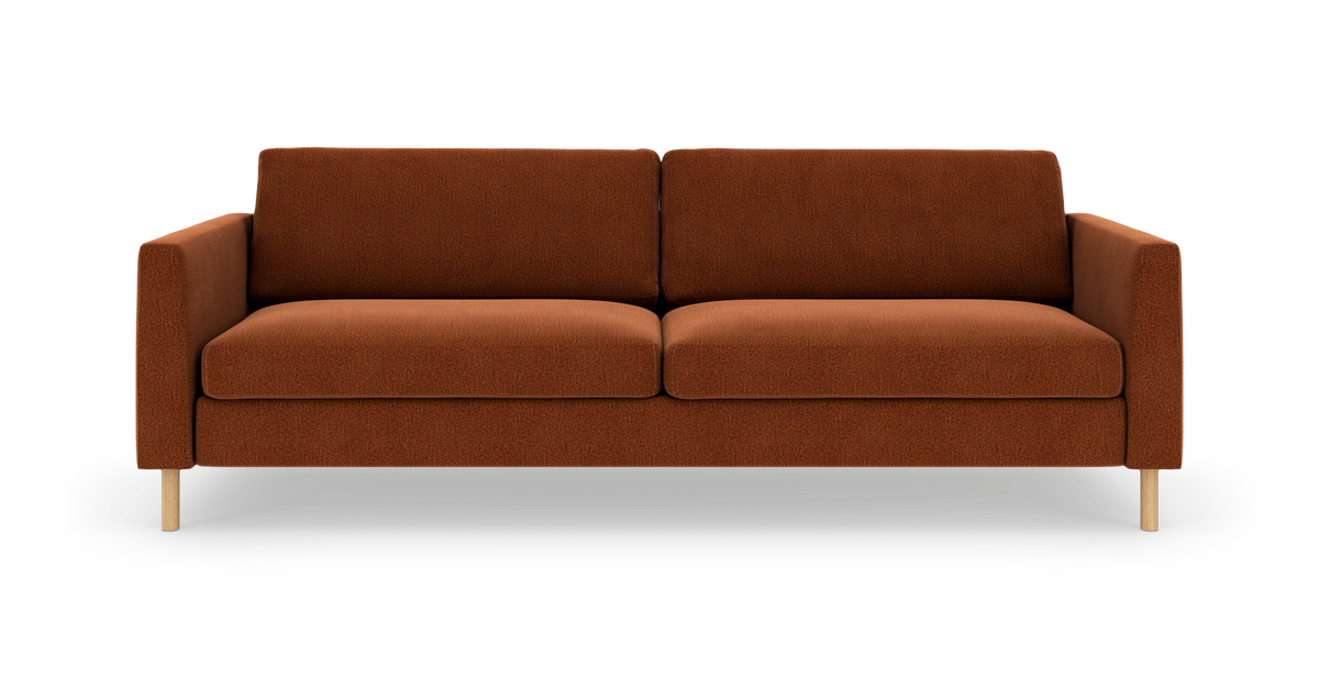 Rustfarvet 3-personers sofa med lige armlæn og lyse træben, frilagt på hvid baggrund.