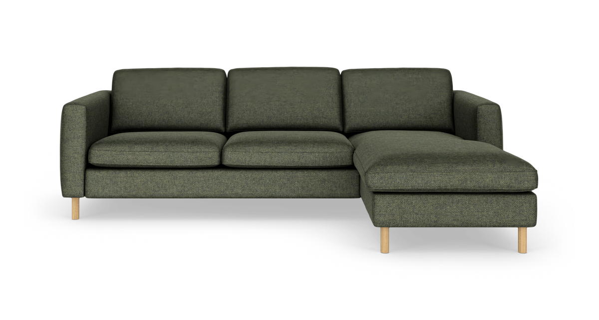 Grøn hjørnesofa med højrevendt chaiselong og lyse træben, frilagt på hvid baggrund.