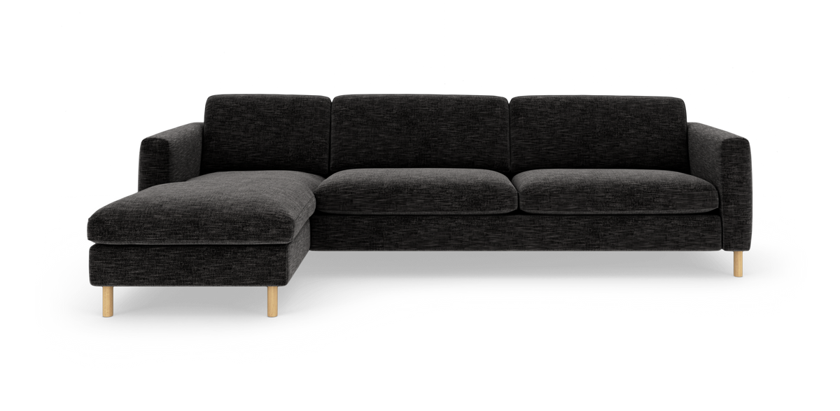 Mørkegrå hjørnesofa med venstrevendt chaiselong og lyse træben, frilagt på hvid baggrund.