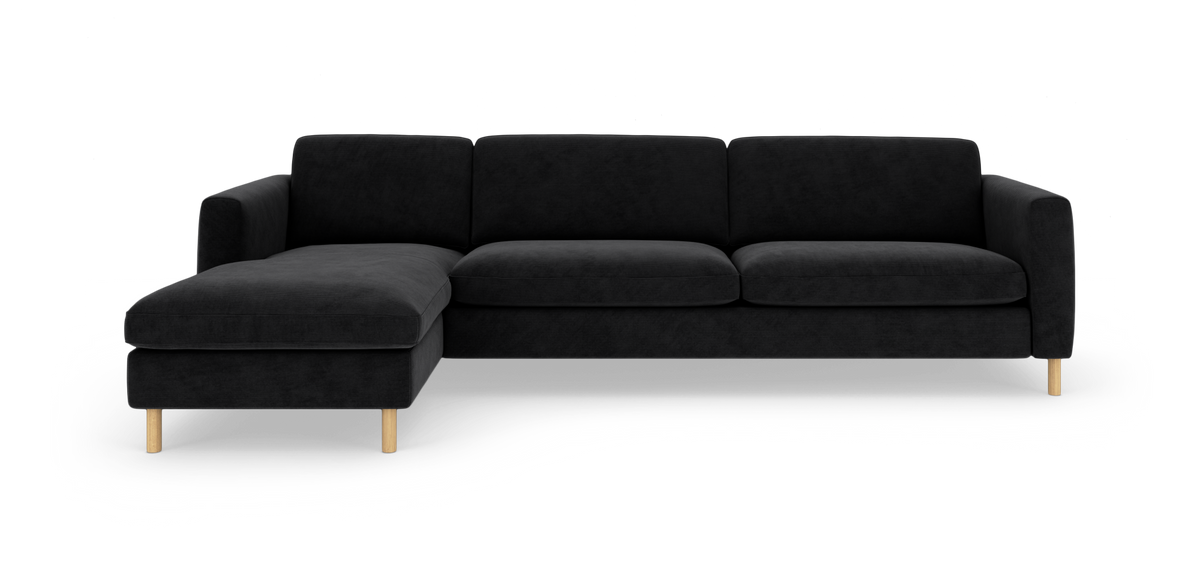 Sort L‑sofa med venstrevendt chaiselong og lyse træben, frilagt på hvid baggrund.