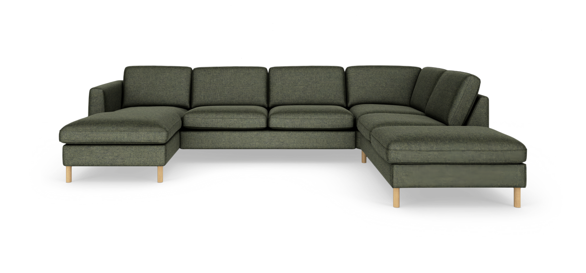 Grøn modulopbygget U-formet hjørnesofa med chaiselong og lyse træben, frilagt på hvid baggrund.