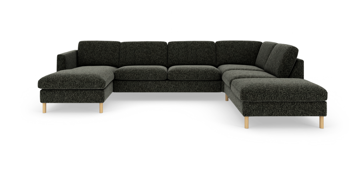 Mørkegrå U-formet modulsofa med lounge-del til venstre og chaiselong til højre, lyse træben, fotograferet i studio.