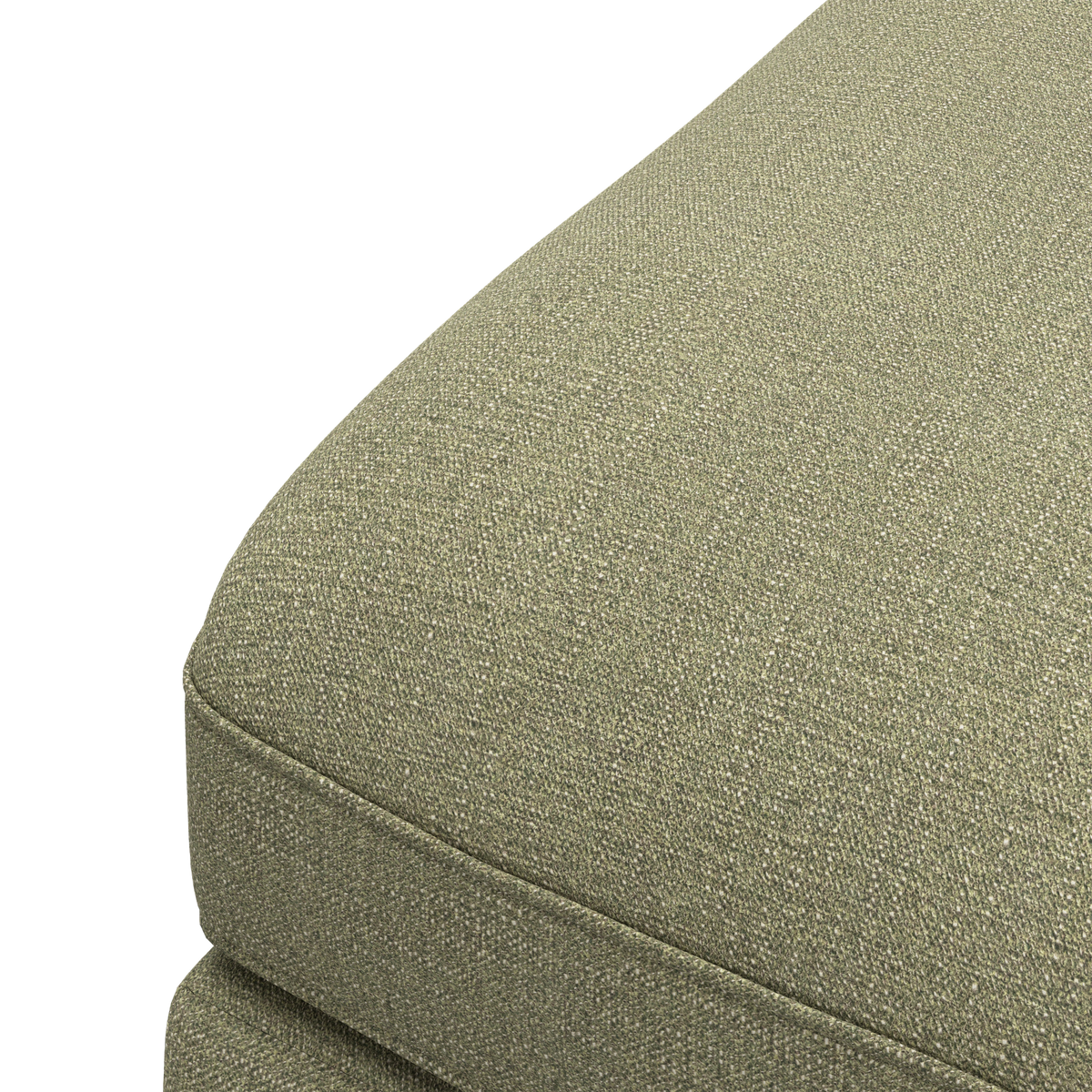 Nærbillede af en grøn, tekstureret sofa-hynde/sofsæde i tekstil på hvid baggrund.