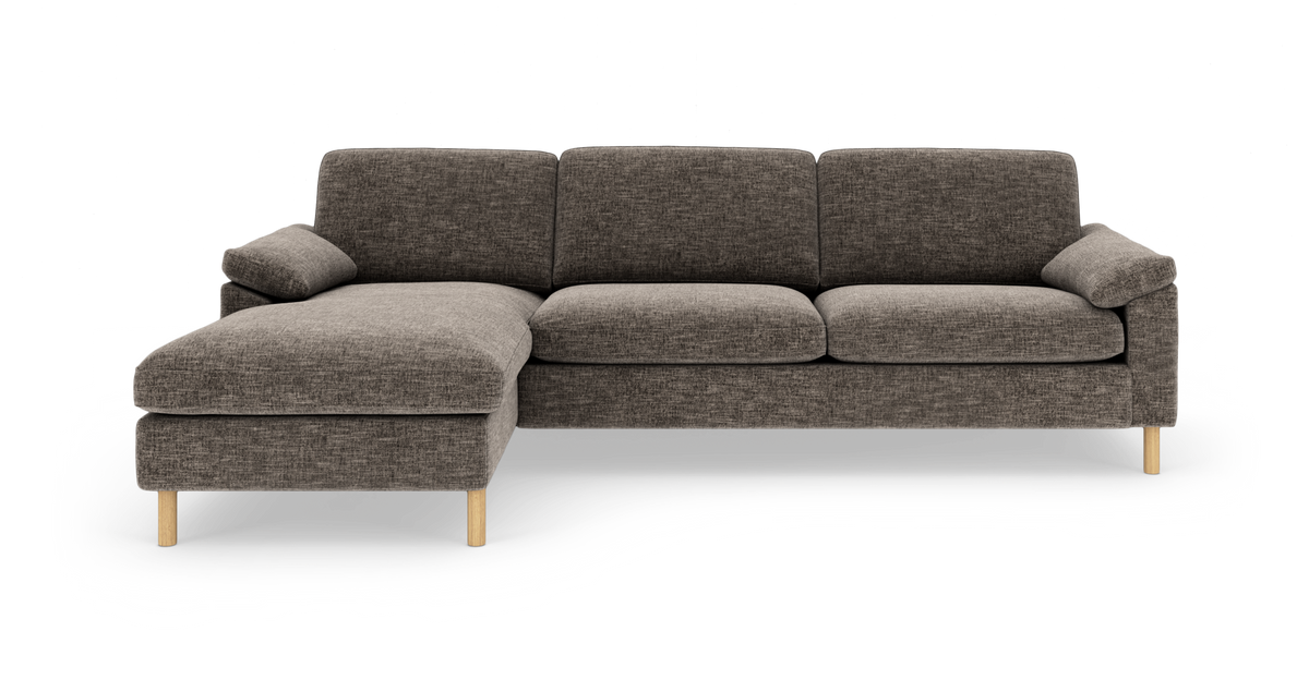 Mørkegrå modulsofa med venstrevendt chaiselong og lyse træben, vist direkte forfra på hvid baggrund.