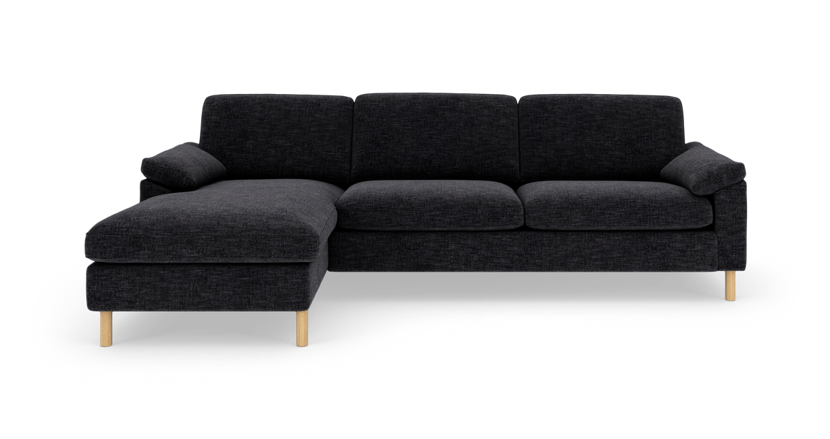 Mørkegrå hjørnesofa med venstrevendt chaiselong og lyse træben, vist på hvid baggrund.