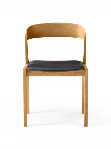 Minimalistisk stol i lys eg med afrundet ryglæn og mørkt lædersæde, frontvisning.