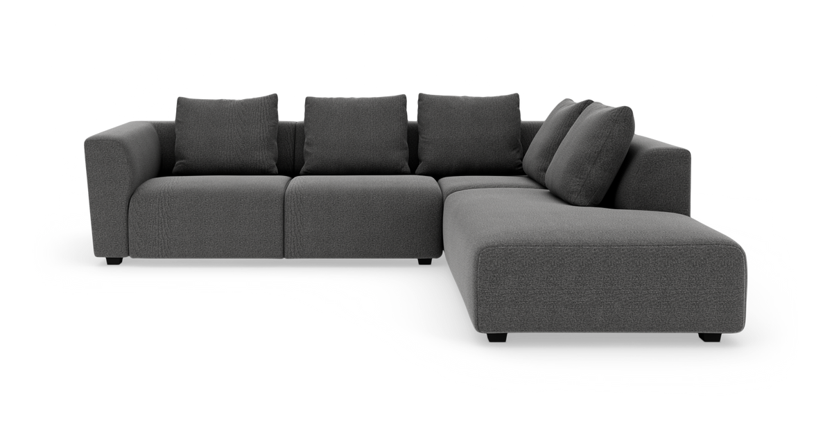 Mørkegrå modulopbygget hjørnesofa med chaiselong til højre på hvid baggrund.